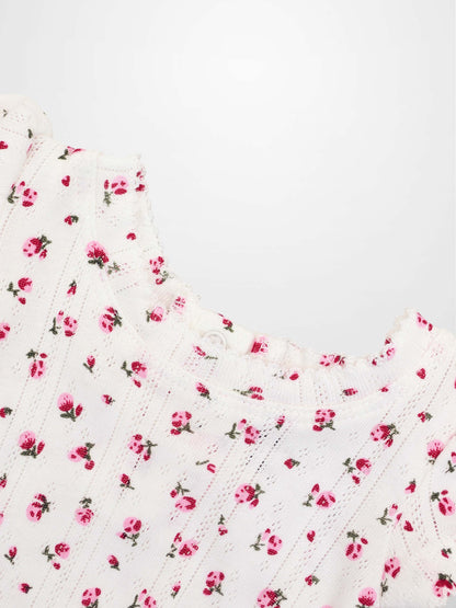 Pointelle Floral Romper for girls by Adee, white knit with pink flowers.