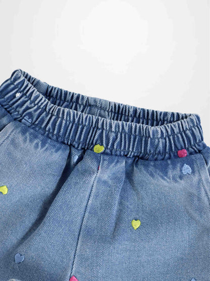 Blue denim shorts with an elastic waistband and colorful embroidered hearts.