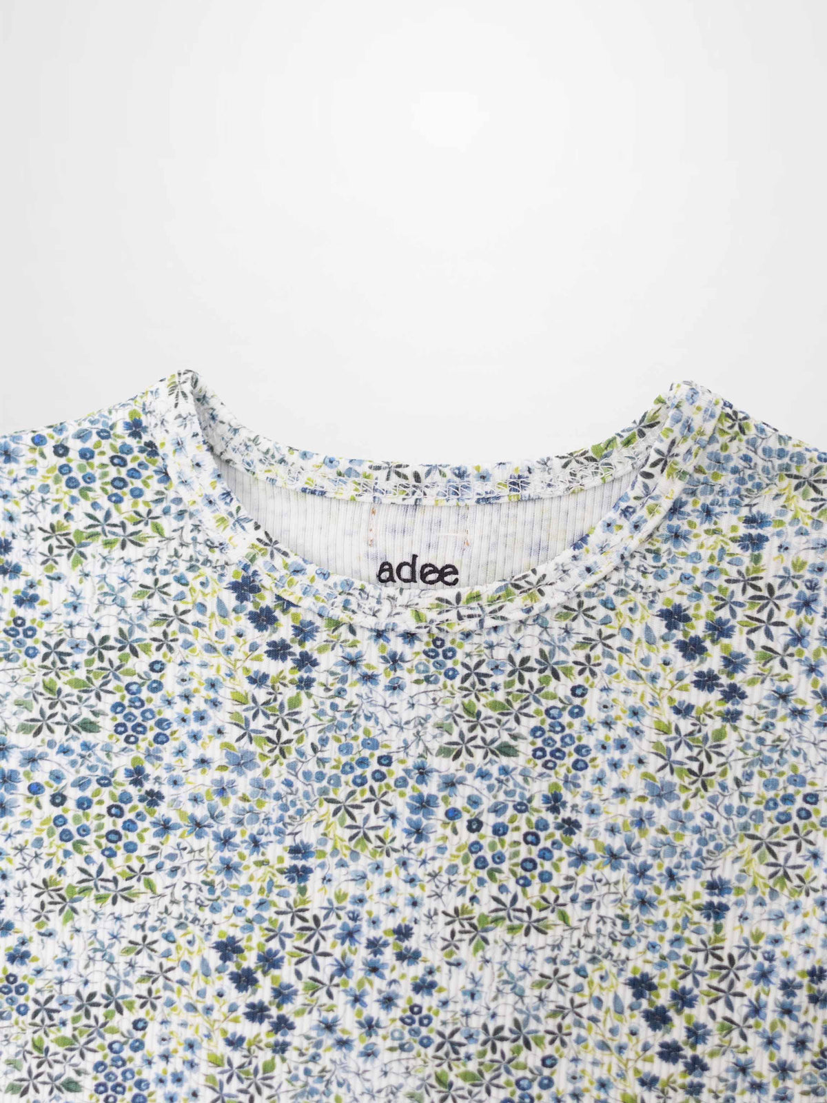 Blue floral girls pajamas top by Adee with a dense blue flower pattern.