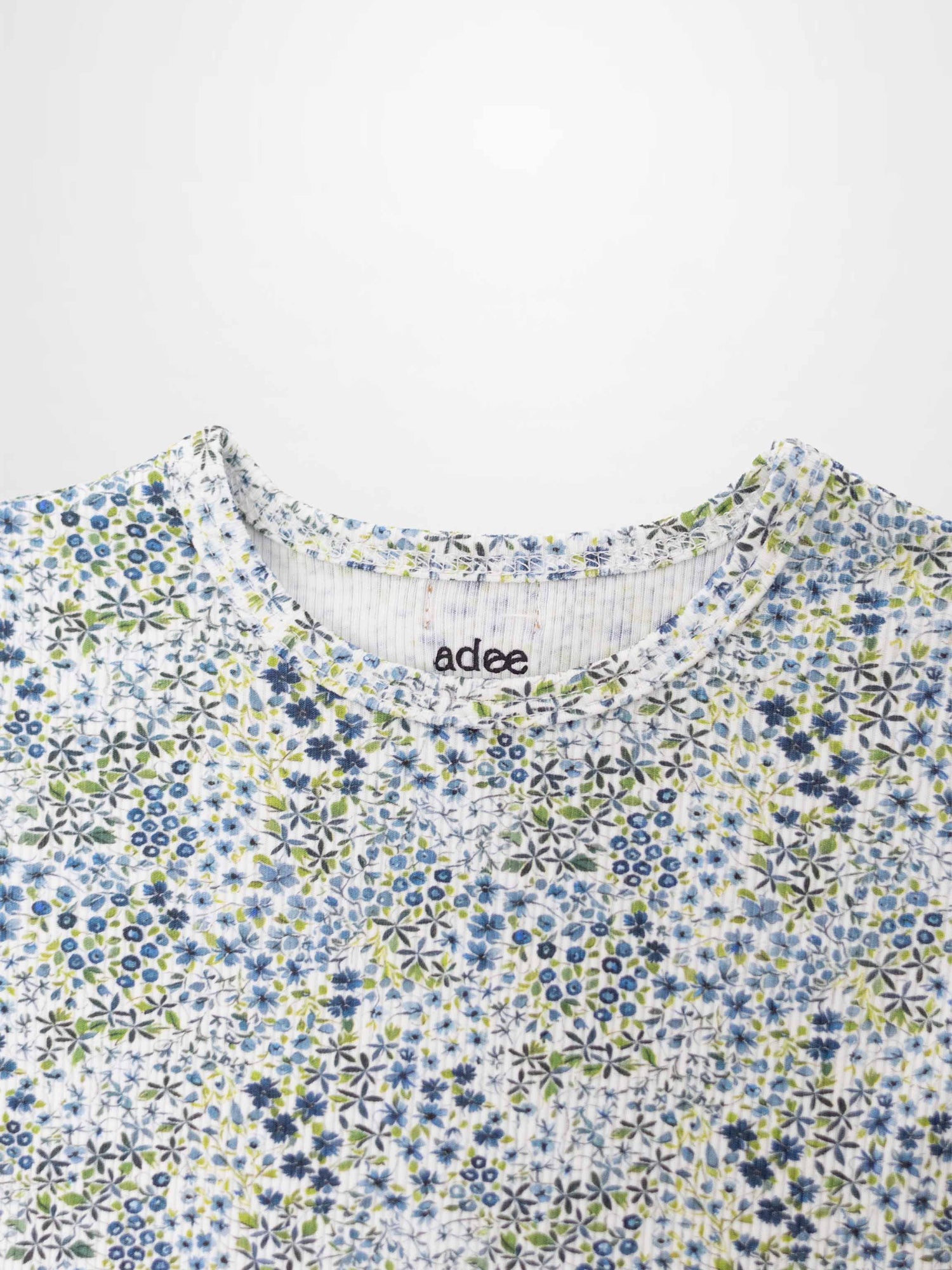 Blue floral girls pajamas top by Adee with a dense blue flower pattern.
