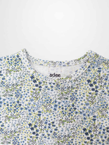 Blue floral girls pajamas top by Adee with a dense blue flower pattern.