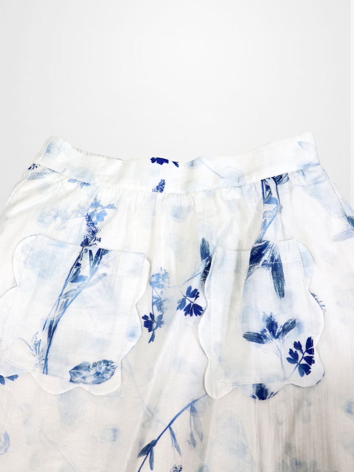 Adee Blue Flower Skirt for girls, dressy white fabric with blue floral print and scalloped pockets