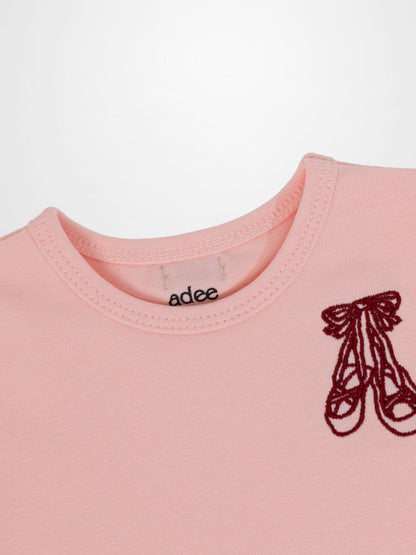 Short sleeve T-shirt by Adee in light pink with a red embroidered emblem.