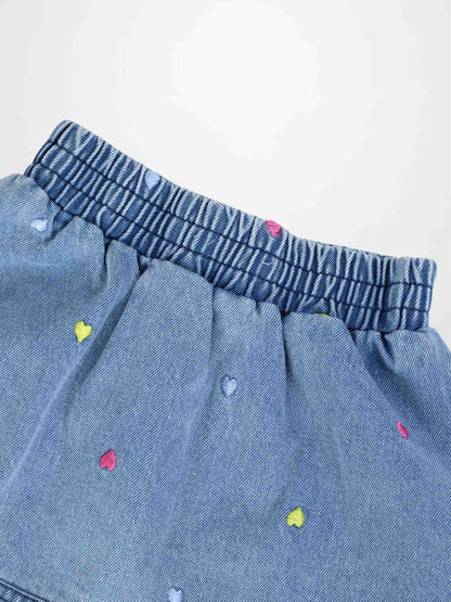 Light-wash denim skirt with multicolor embroidered hearts and an elastic waistband.