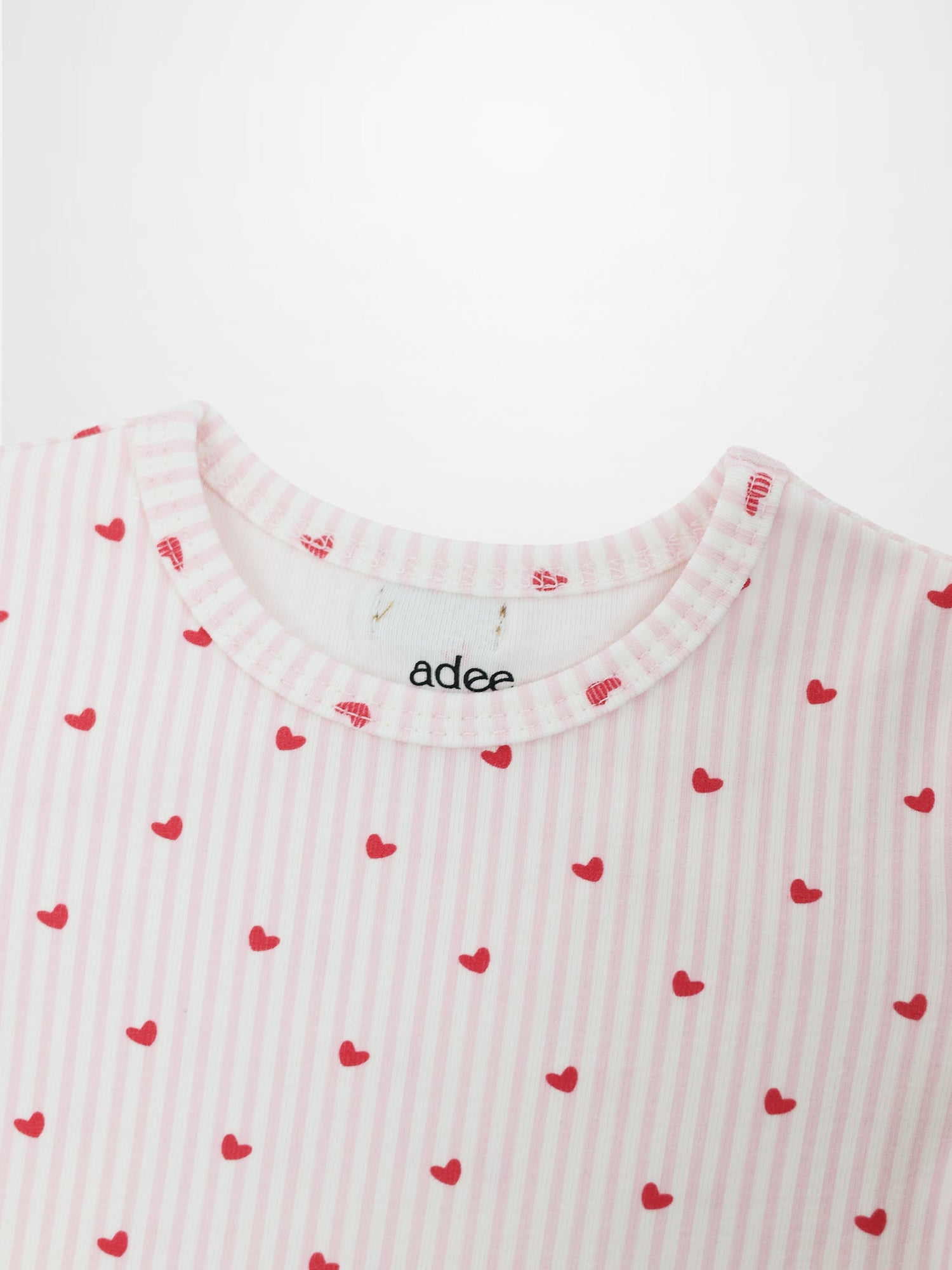 Pink Heart Pajamas for girls by Adee; pink striped fabric with red hearts.