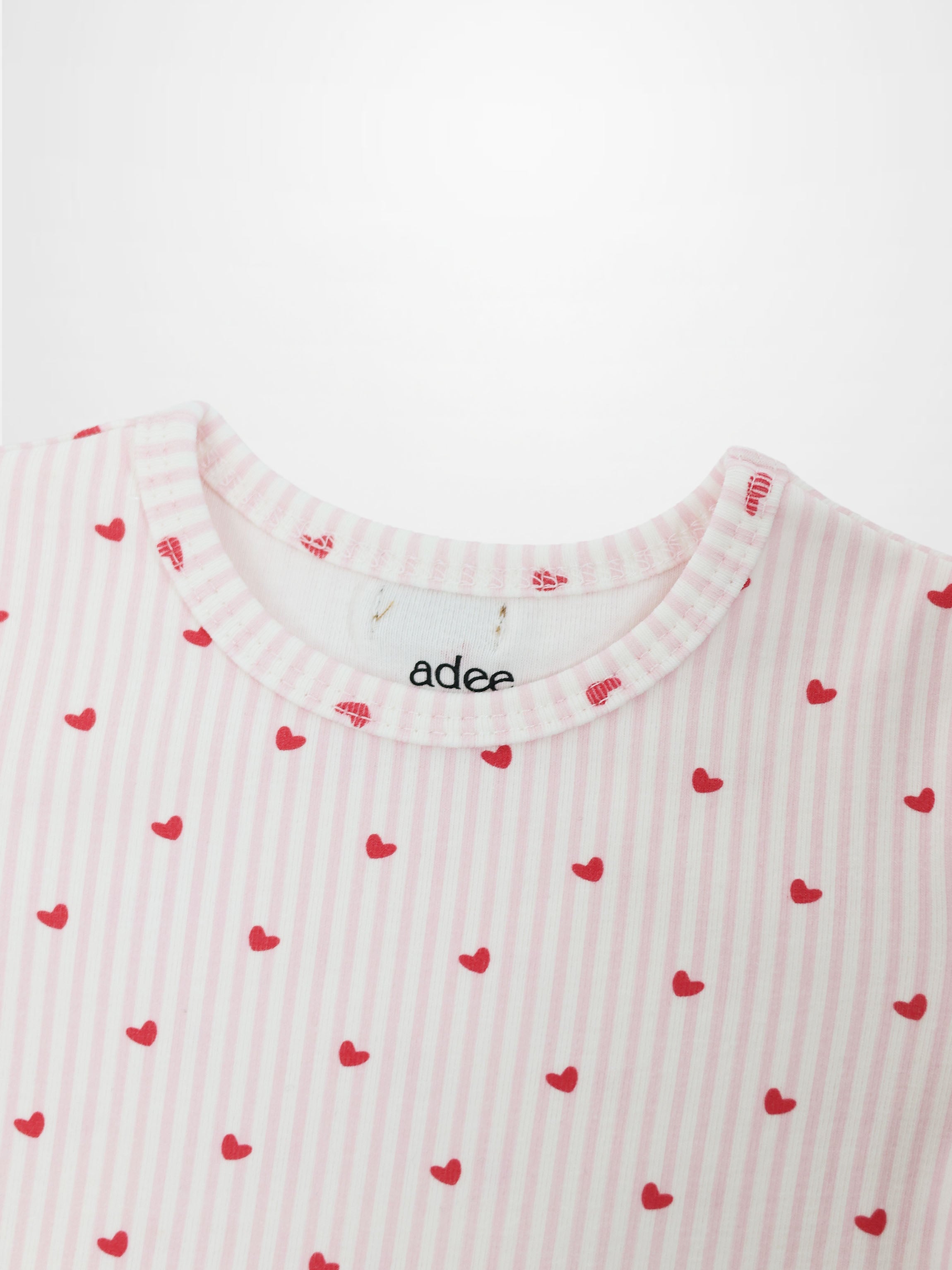 Pink Heart Pajamas for girls by Adee; pink striped fabric with red hearts.