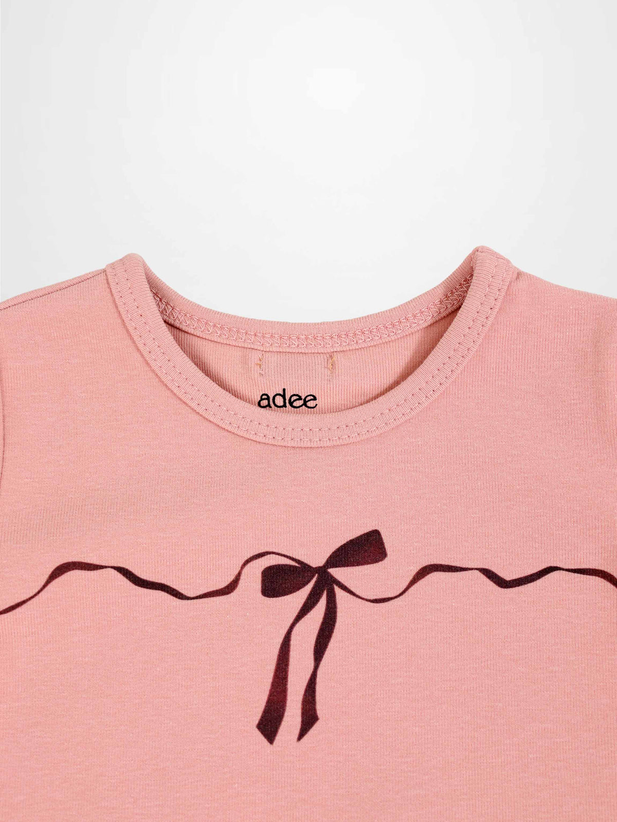 Adee Bow Pajamas for girls, pink top with dark ribbon bow graphic across chest.