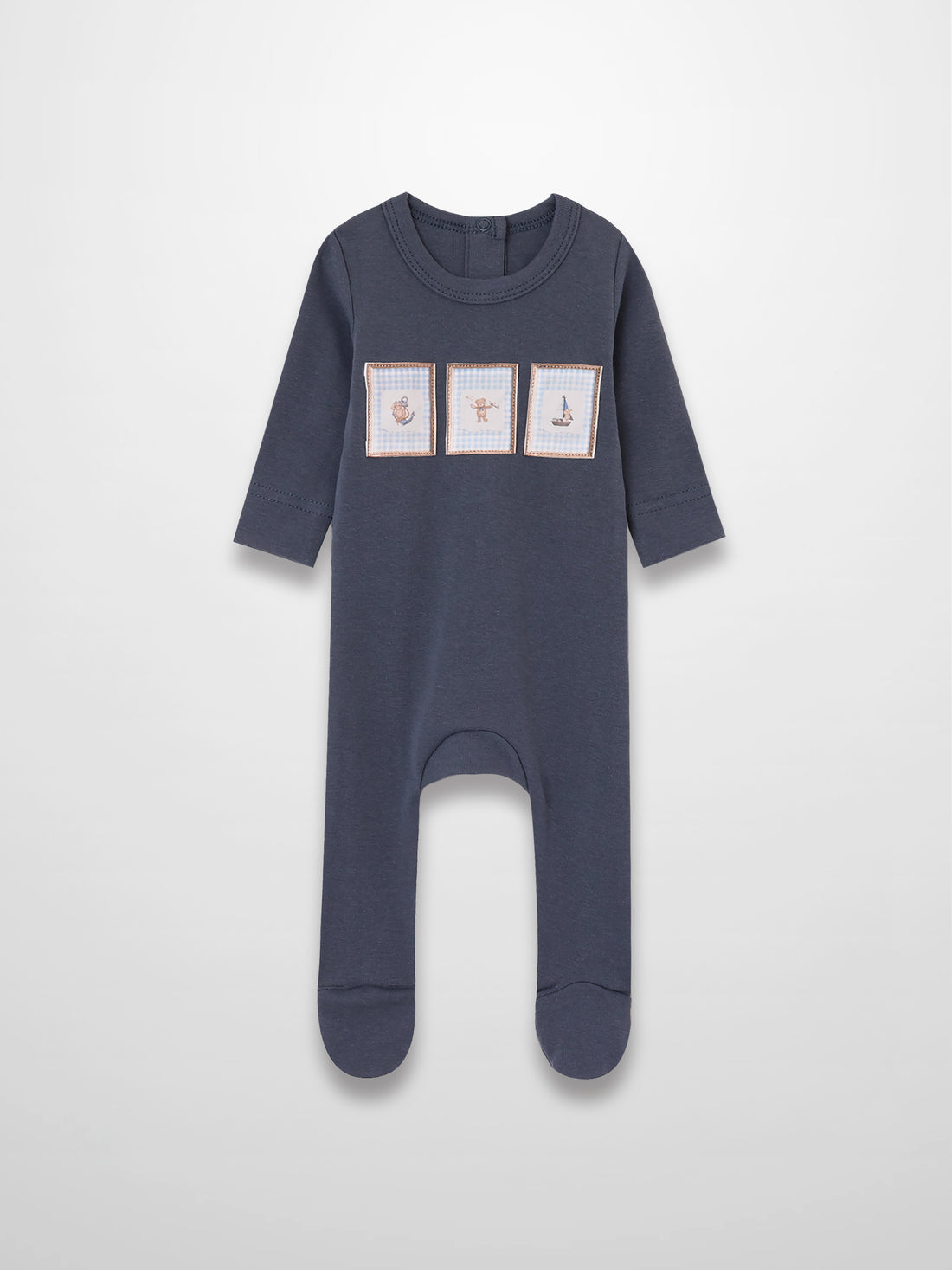 Navy blue baby jumpsuit with three framed front patches (anchor, teddy bear, sailboat) in tan trim with blue gingham.