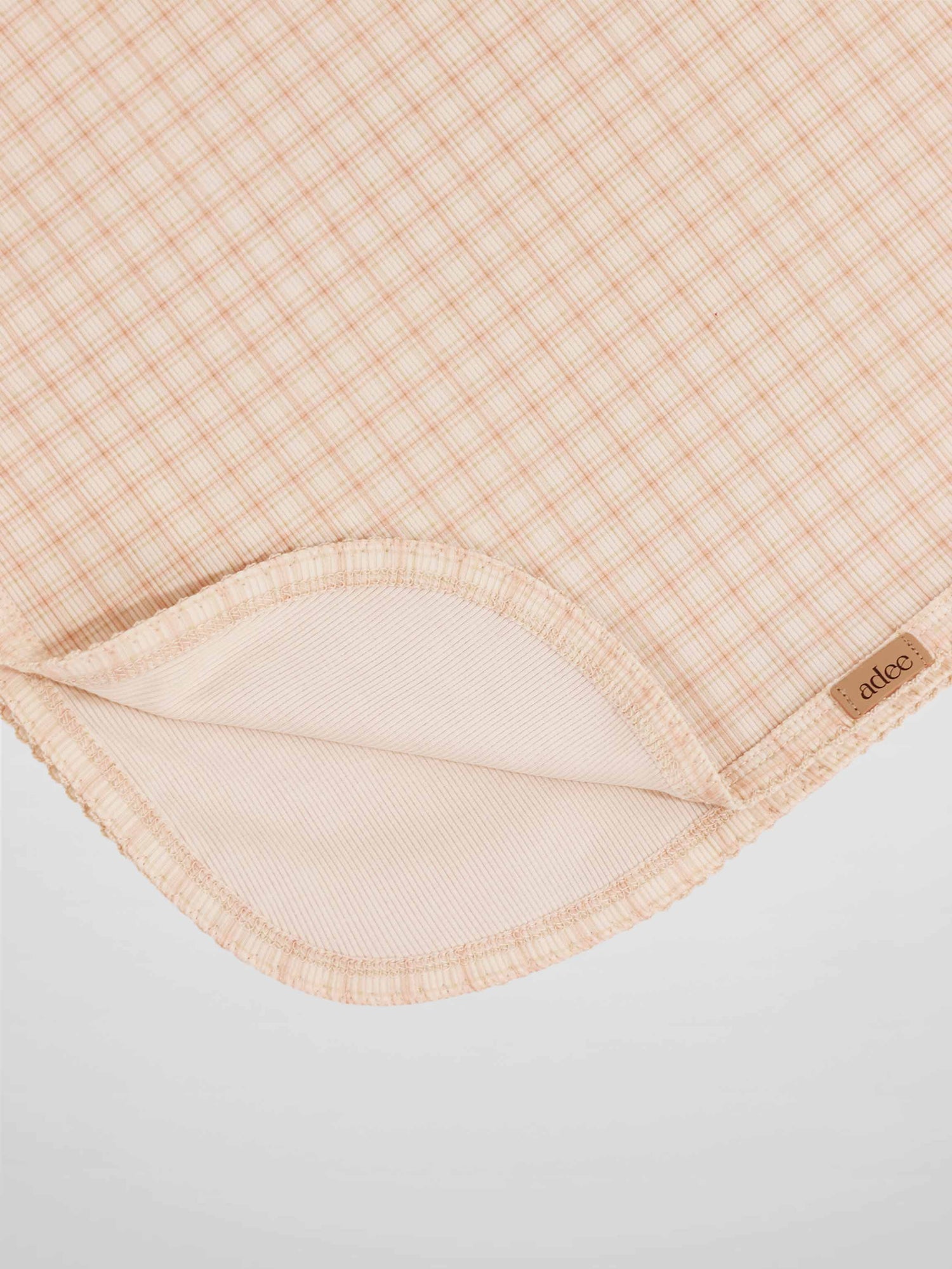 Oatmeal Grid Blanket - Pink by Adee, a girls receiving swaddle blanket with a light pink grid pattern.