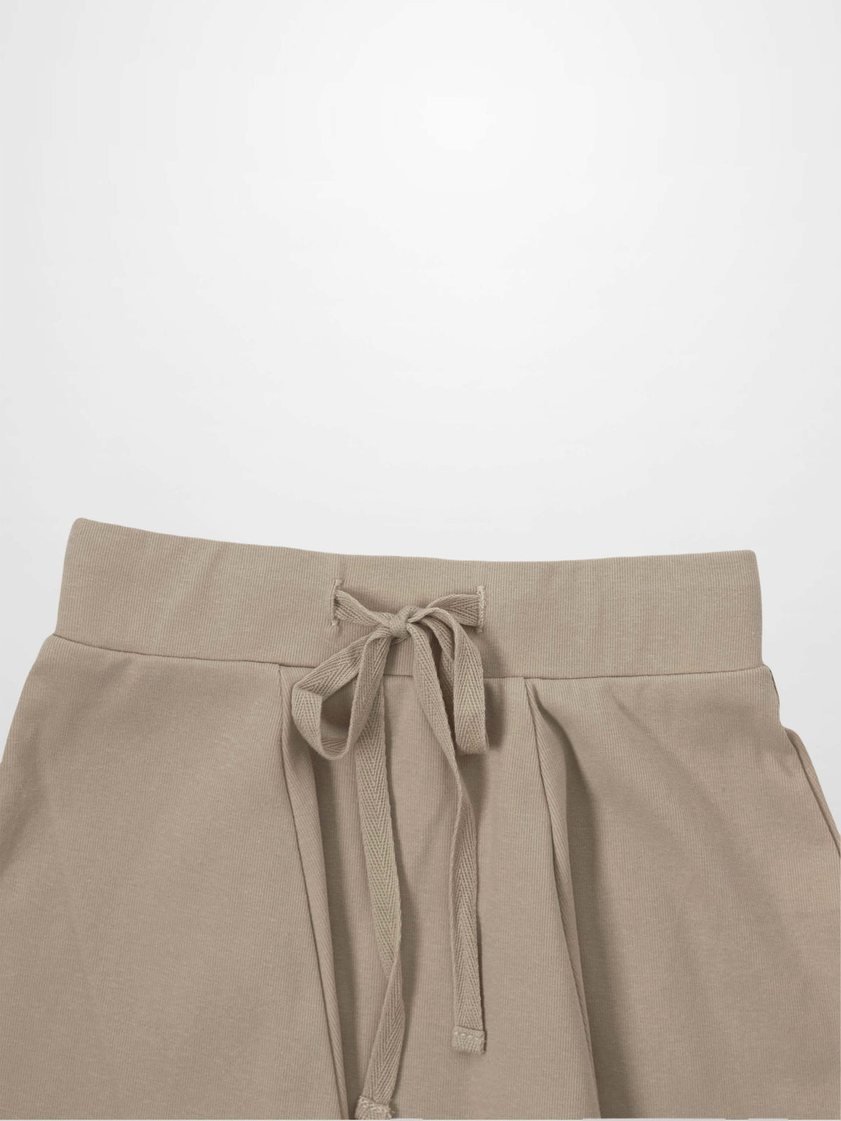 Taupe six-panel skirt with wide elastic waistband and front tie belt.