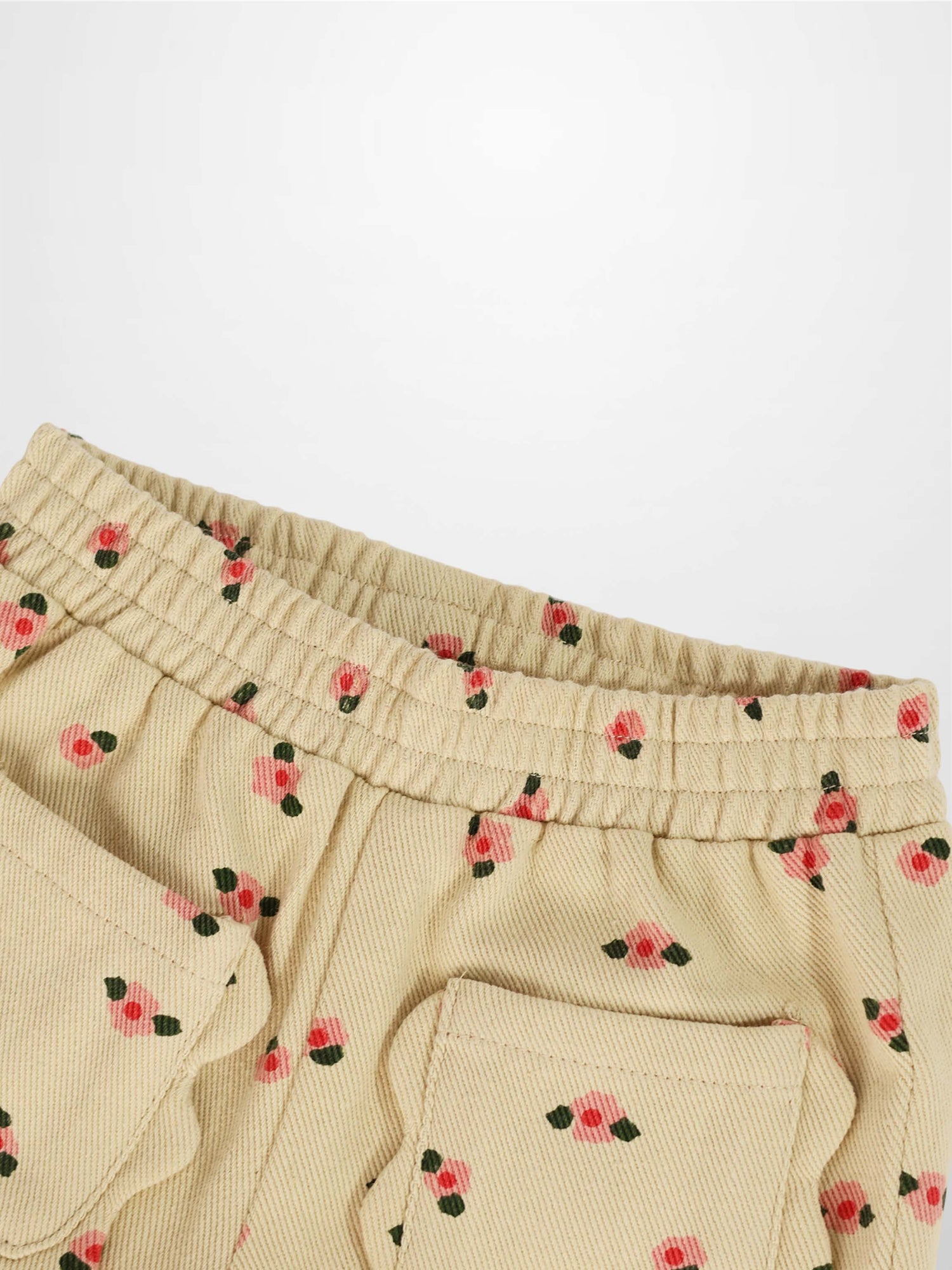 Tan Floral Shorts with pink blossom print and green leaves, elastic waistband and back pocket.