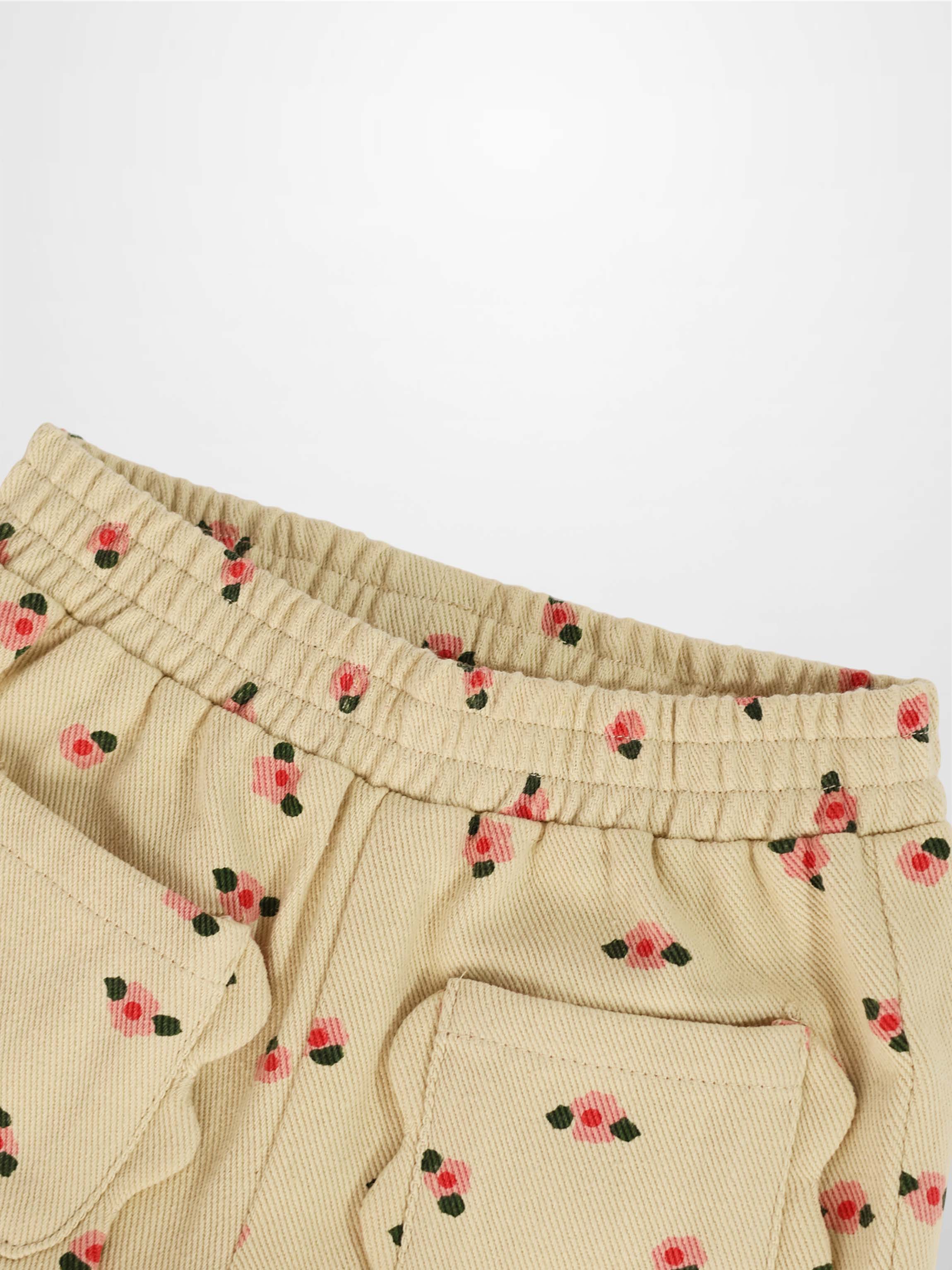 Tan Floral Shorts with pink blossom print and green leaves, elastic waistband and back pocket.