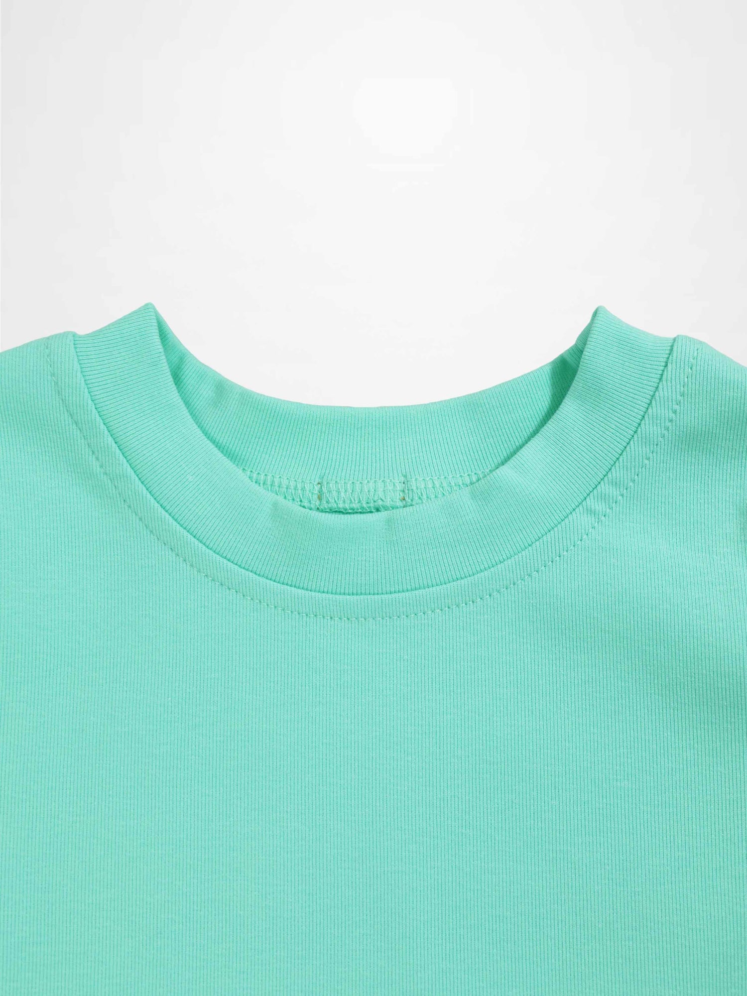 Mint green thin ribbed T-shirt neckline, close-up of fabric and stitching.