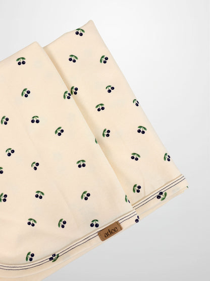 Blue Cherry Blanket by Adee; cream fabric with scattered blue cherry print (set of 2).