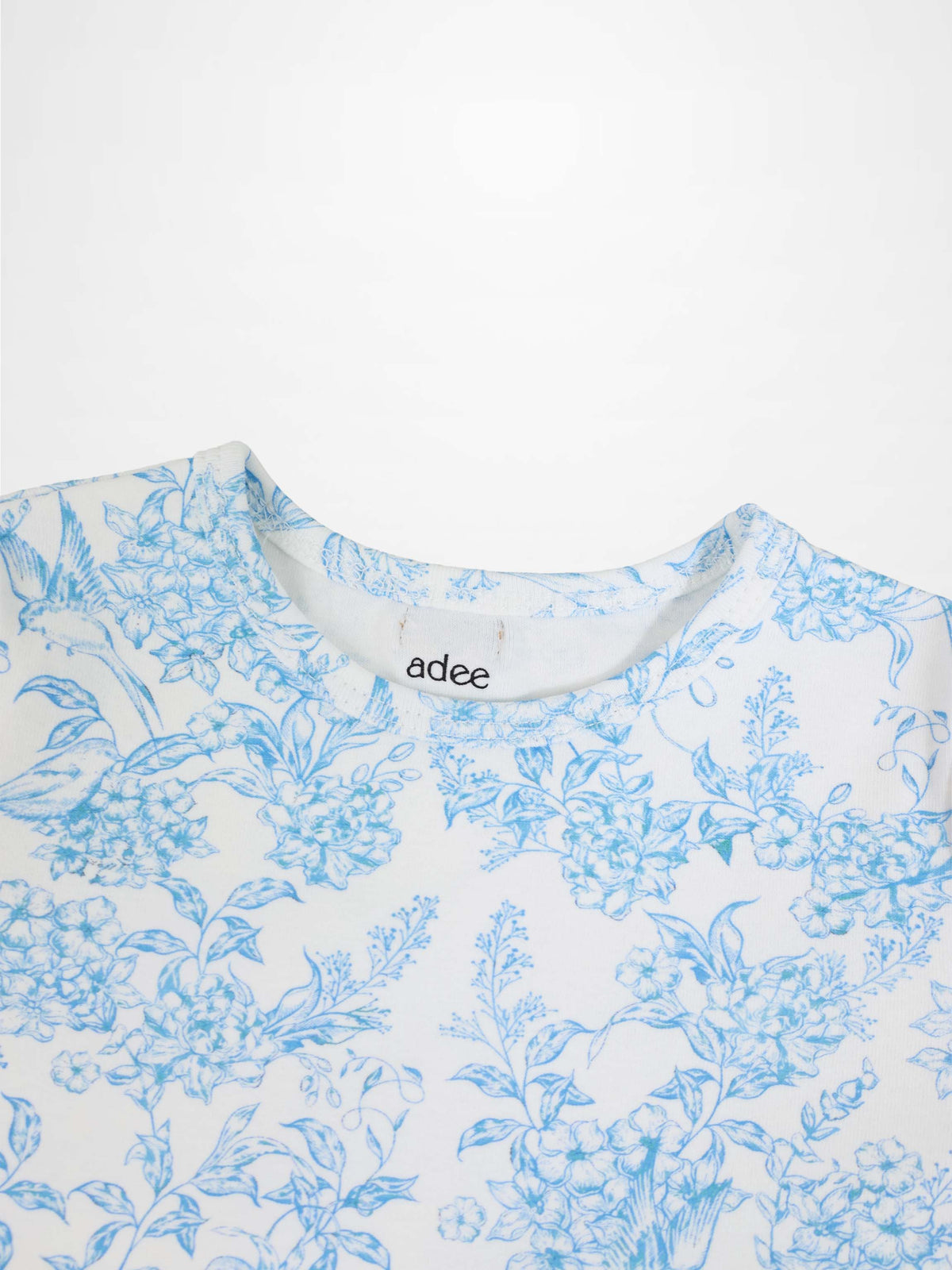 Blue flowered short sleeve T-shirt for girls by Adee, white fabric with blue floral print.