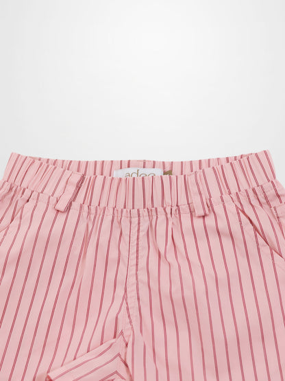 Pink cotton shorts with thin red vertical stripes, elastic waist, and belt loops.