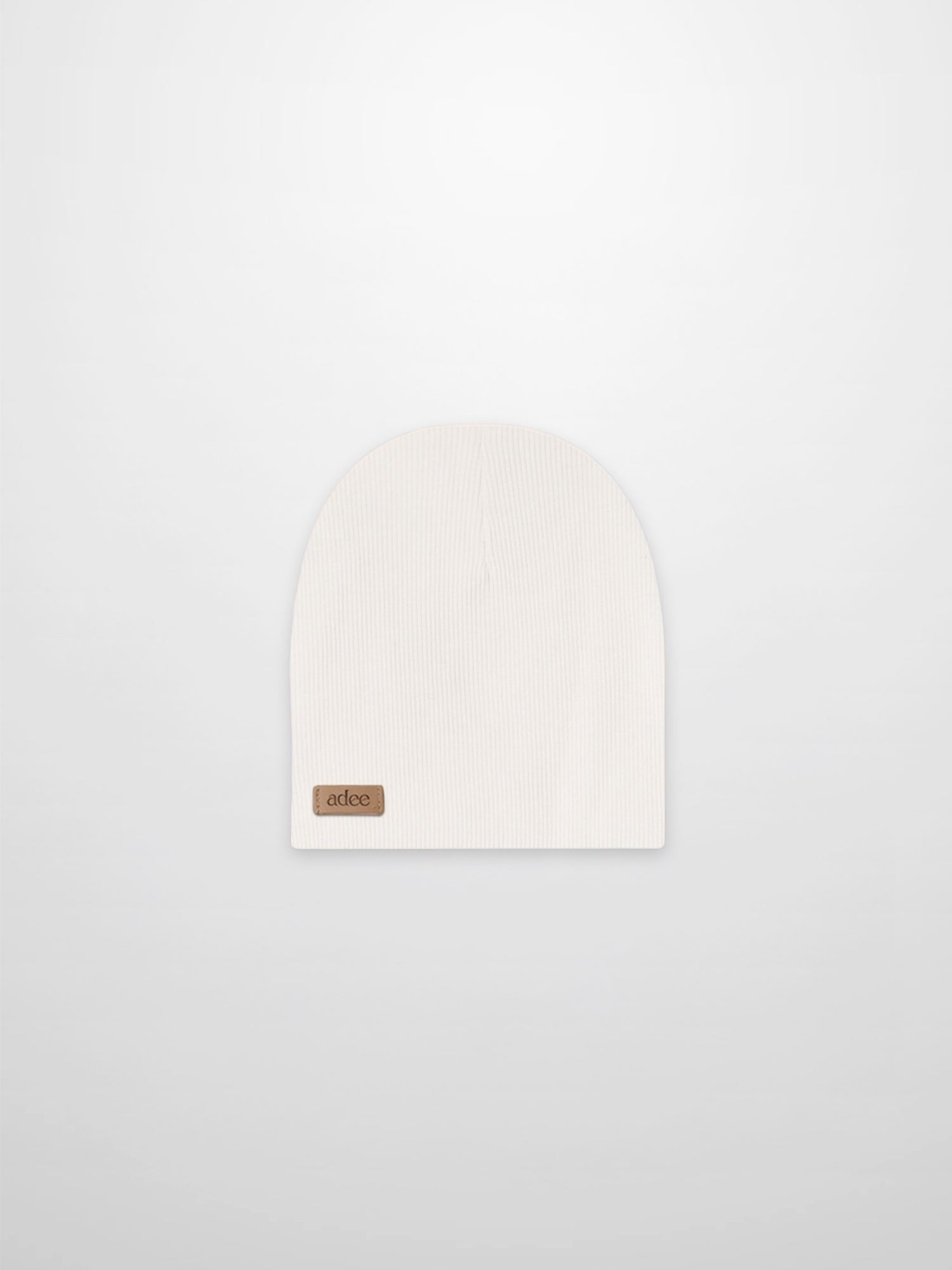 Thin ribbed white beanie by Adee; unisex baby/toddler knit hat with a small leather logo patch, ideal for cold days.