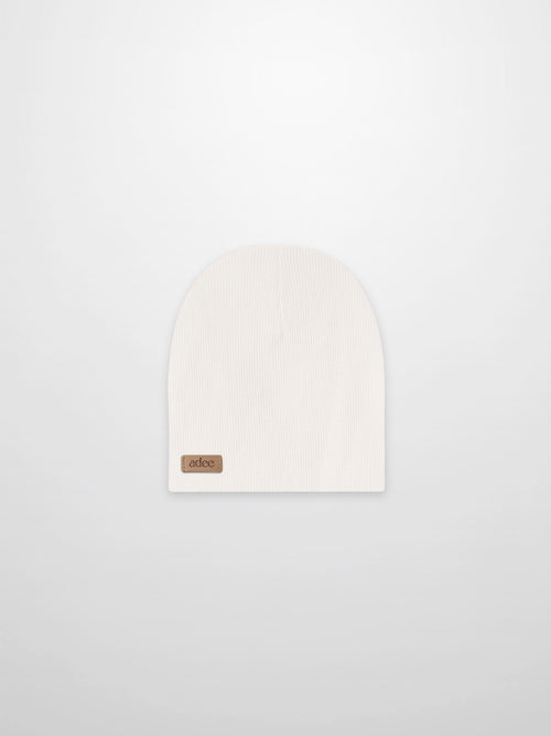 Thin ribbed white beanie by Adee; unisex baby/toddler knit hat with a small leather logo patch, ideal for cold days.