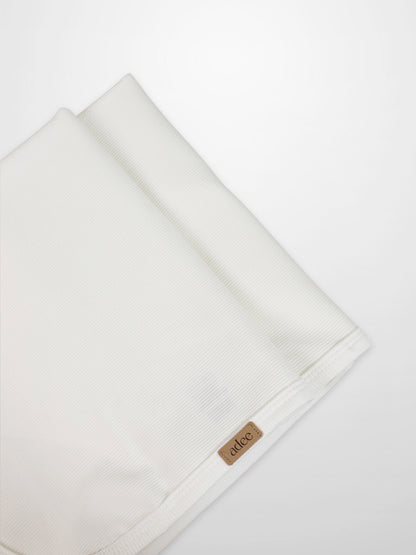 Thin ribbed white blanket by Adee for unisex, lightweight apparel and accessories, with visible brand tag at the edge.