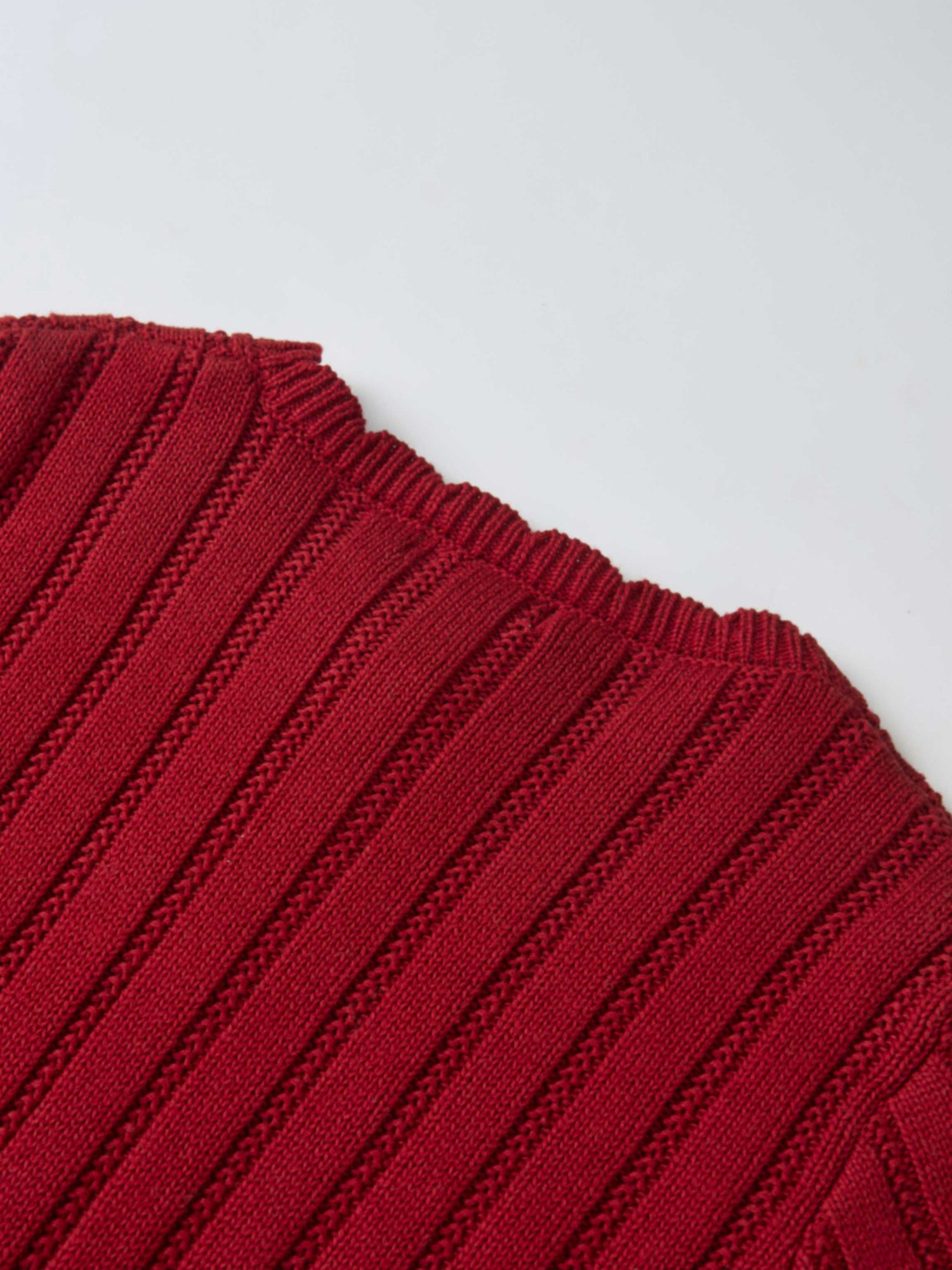 Knit cardigan for girls in red, close-up of ribbed knit fabric.