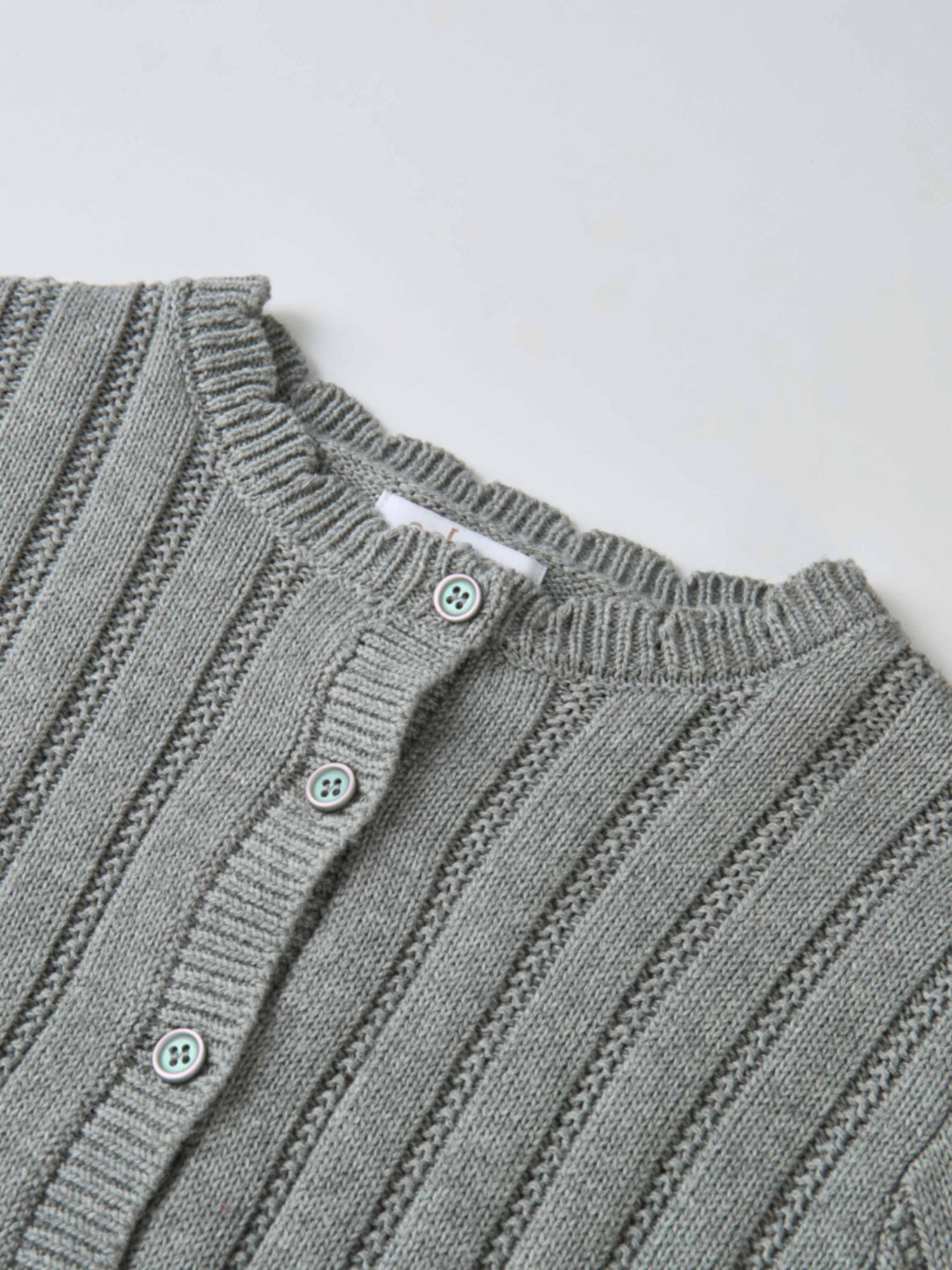 Knit cardigan for girls, grey; dressy top with ribbed texture and pastel buttons.
