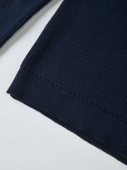 Ruffle Collar Knit Sweater in navy; close-up of ribbed knit fabric.