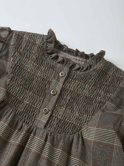 Plaid dress for girls in grey with smocked neckline, ruffle trim and button placket.