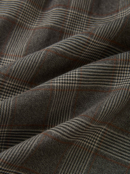 Plaid dress fabric in grey with small checks and brown accents.