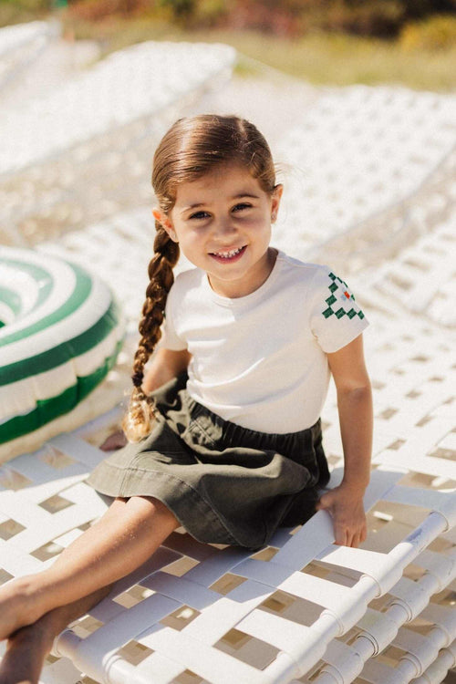 Little girl in green denim skirt