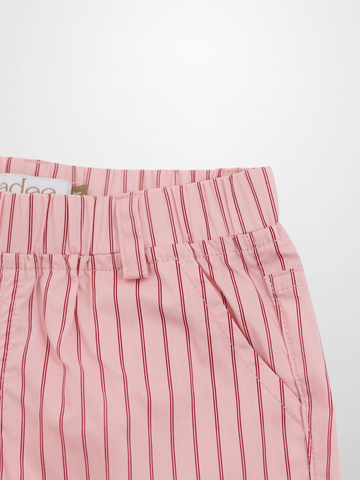 Pink striped cotton shorts with elastic waistband and diagonal front pocket.