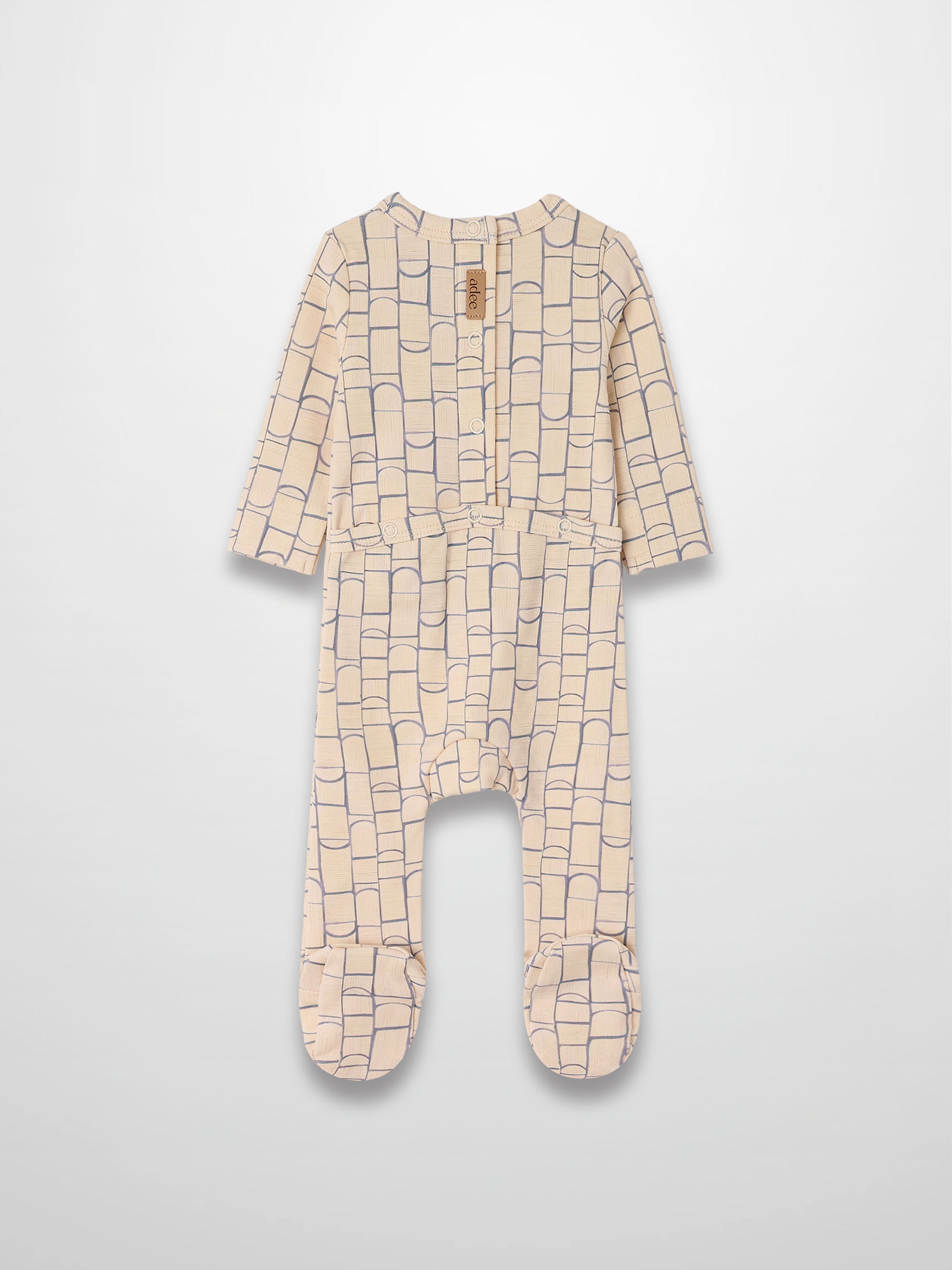 Geometric Crossover Stretchy jumpsuit in beige with light-blue rounded-rectangle arches; crossover front.