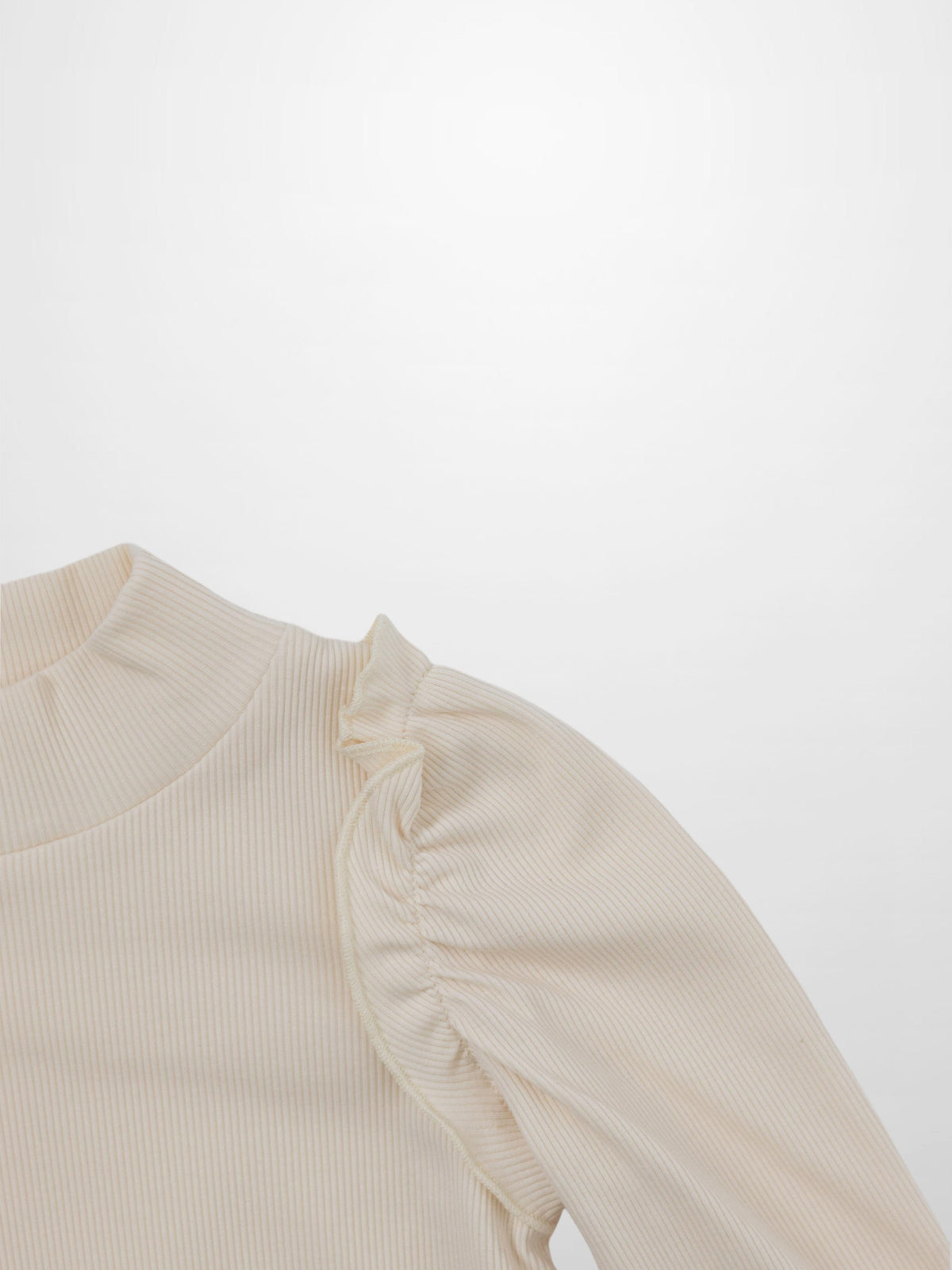 Ruffle puff sleeve mock neck shirt in ivory ribbed knit