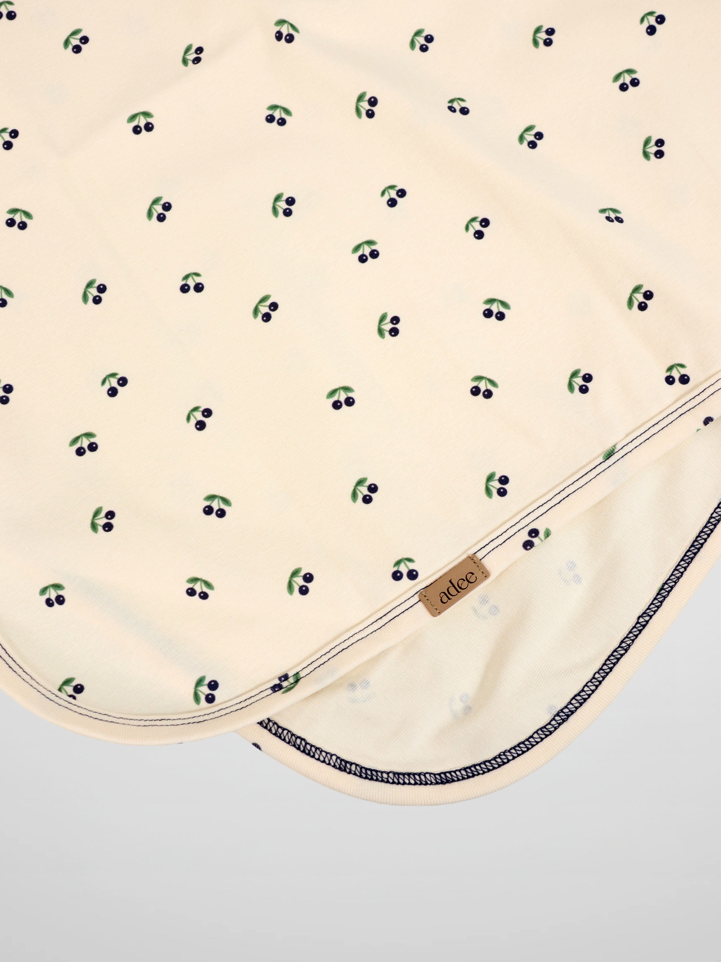 Blue Cherry Blanket by Adee; cream boys swaddle blanket with scattered blue cherries