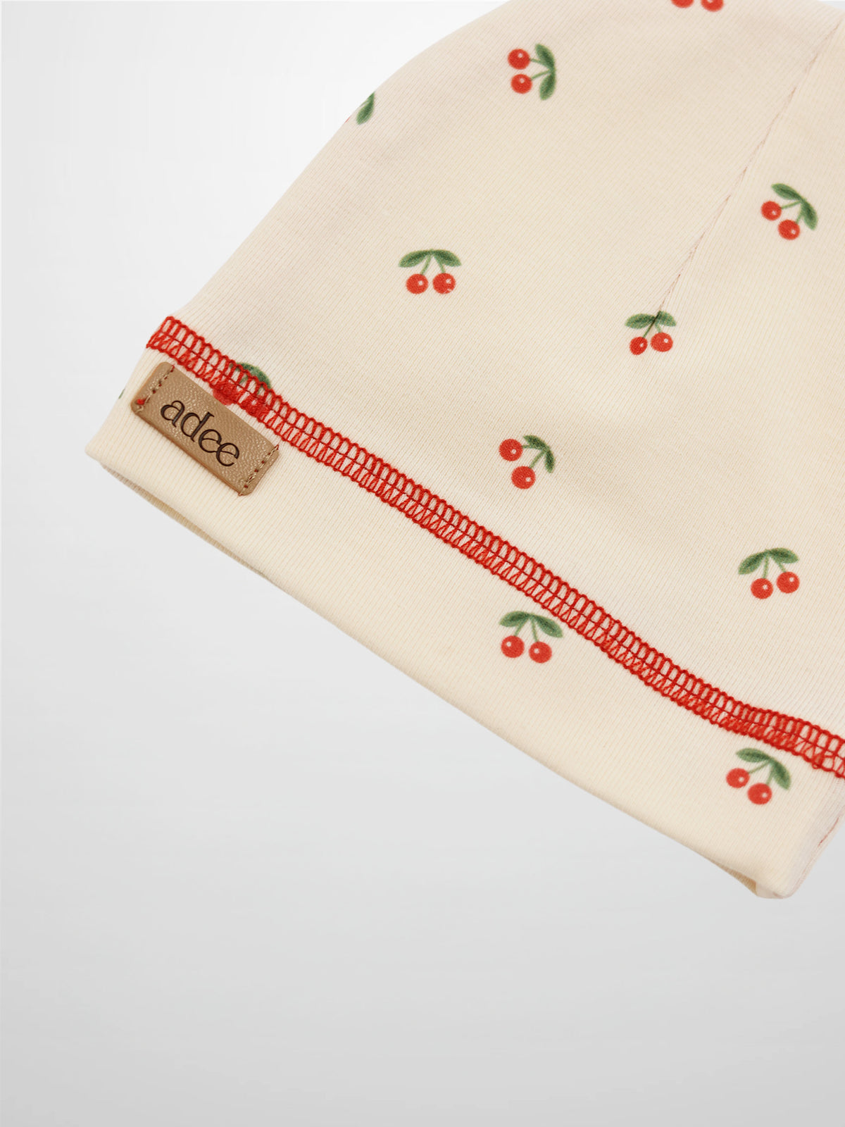 Red cherry hat for girls by Adee in beige knit with red stitching