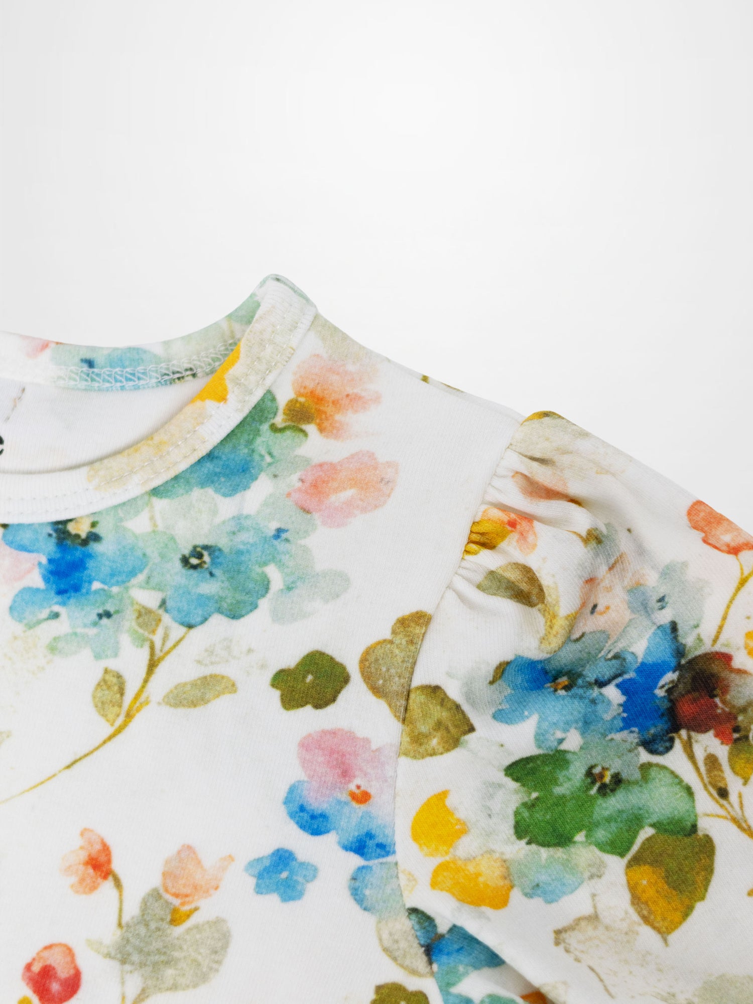 Pastel Flower Short Puff Sleeve T-shirt for girls; white fabric with pastel floral print.