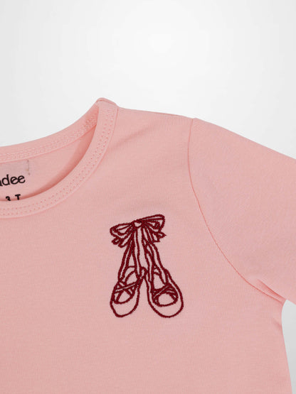 Light pink 3/4 sleeve T-shirt with burgundy ballet slippers emblem on chest.