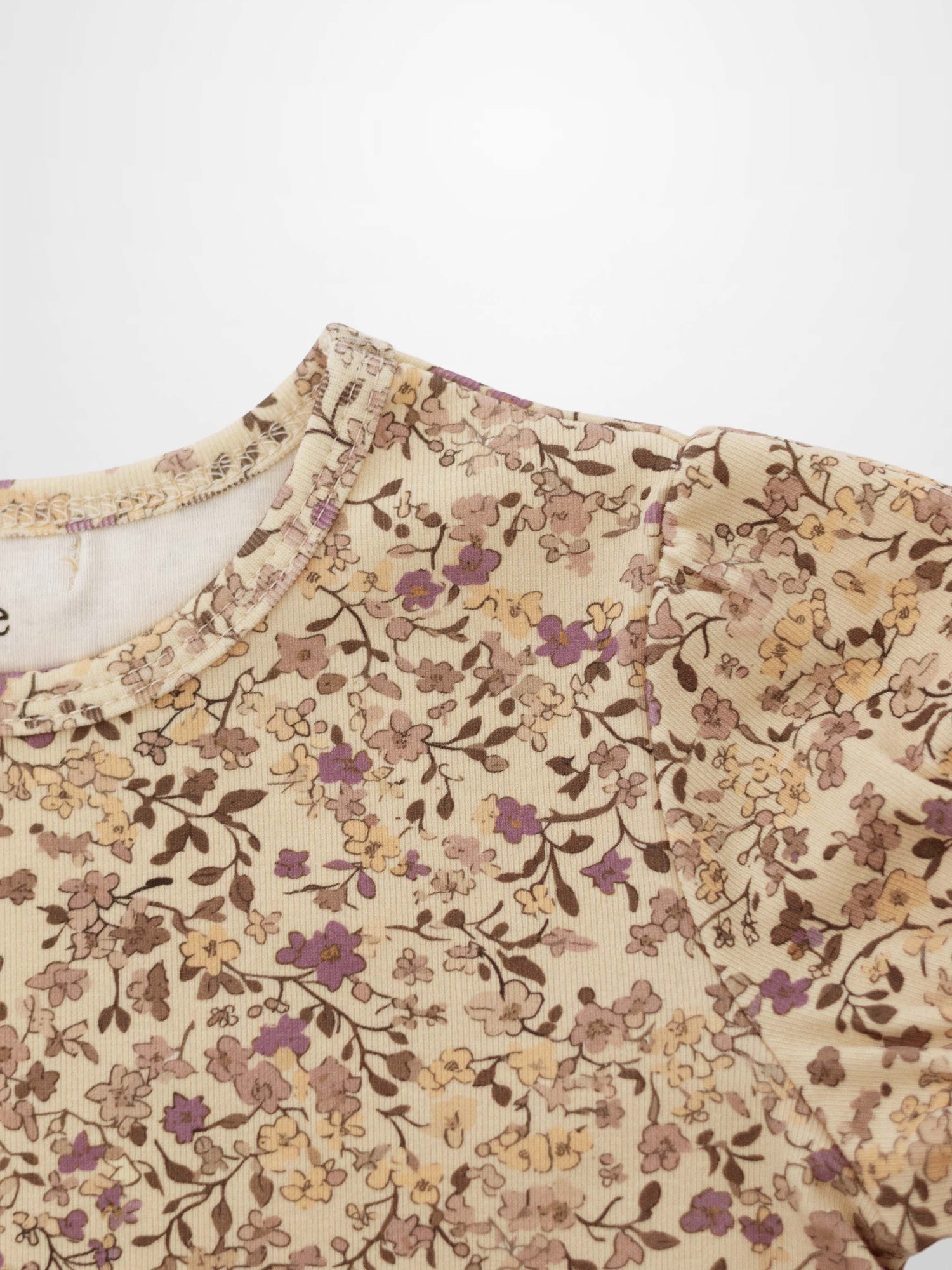 Girls floral T-shirt in beige fabric with purple and brown blossoms, patterned top for everyday wear