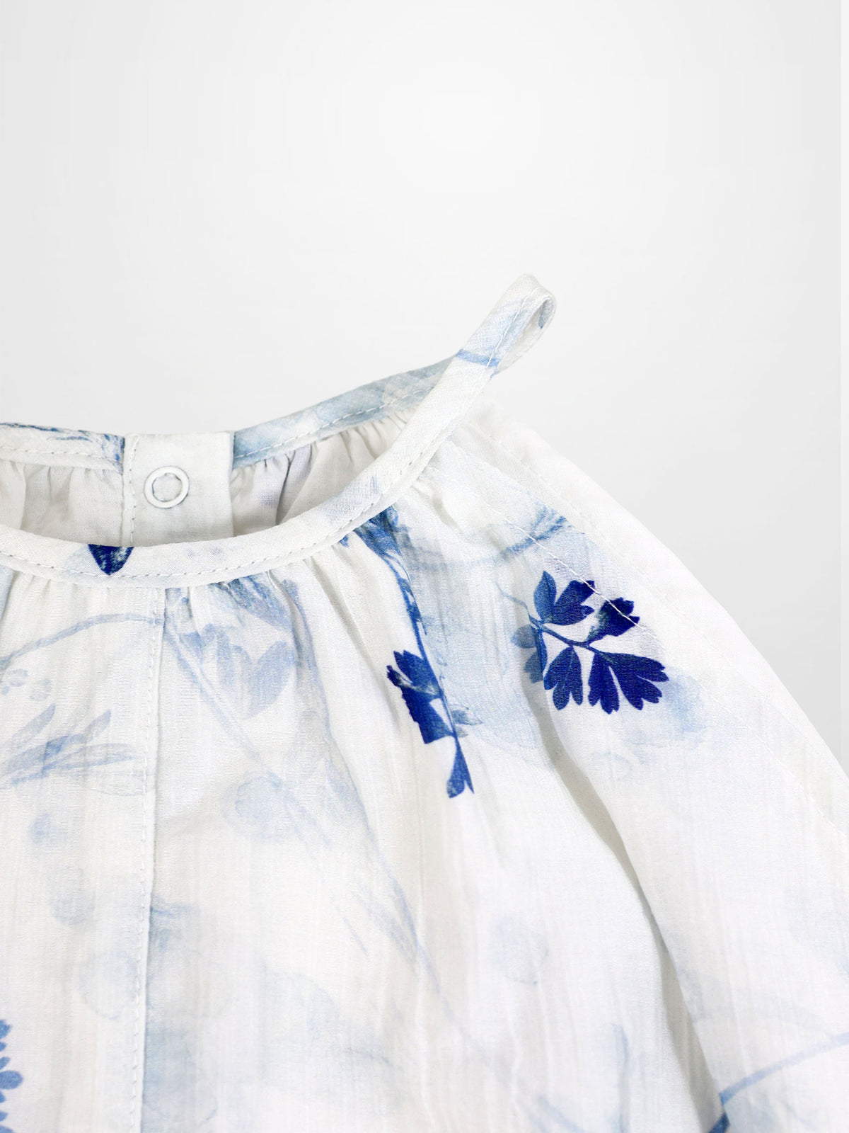 Blue Flower Romper for girls, dressy white fabric with blue floral print and shoulder strap detail