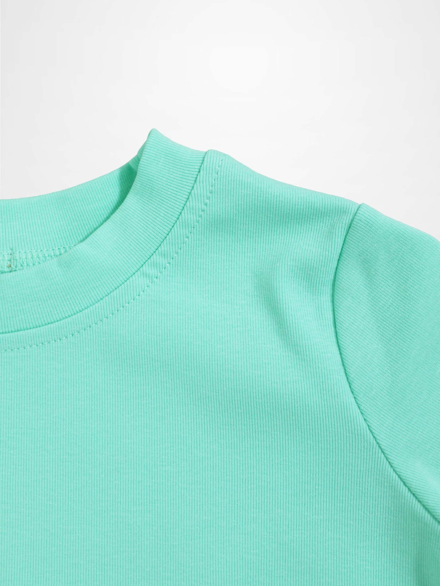 Mint green thin ribbed T-shirt neckline with shoulder seam close-up.