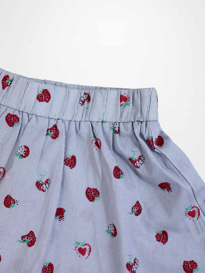 Strawberry Print Skirt for girls; blue pinstripe fabric with red strawberry motifs and elastic waistband.