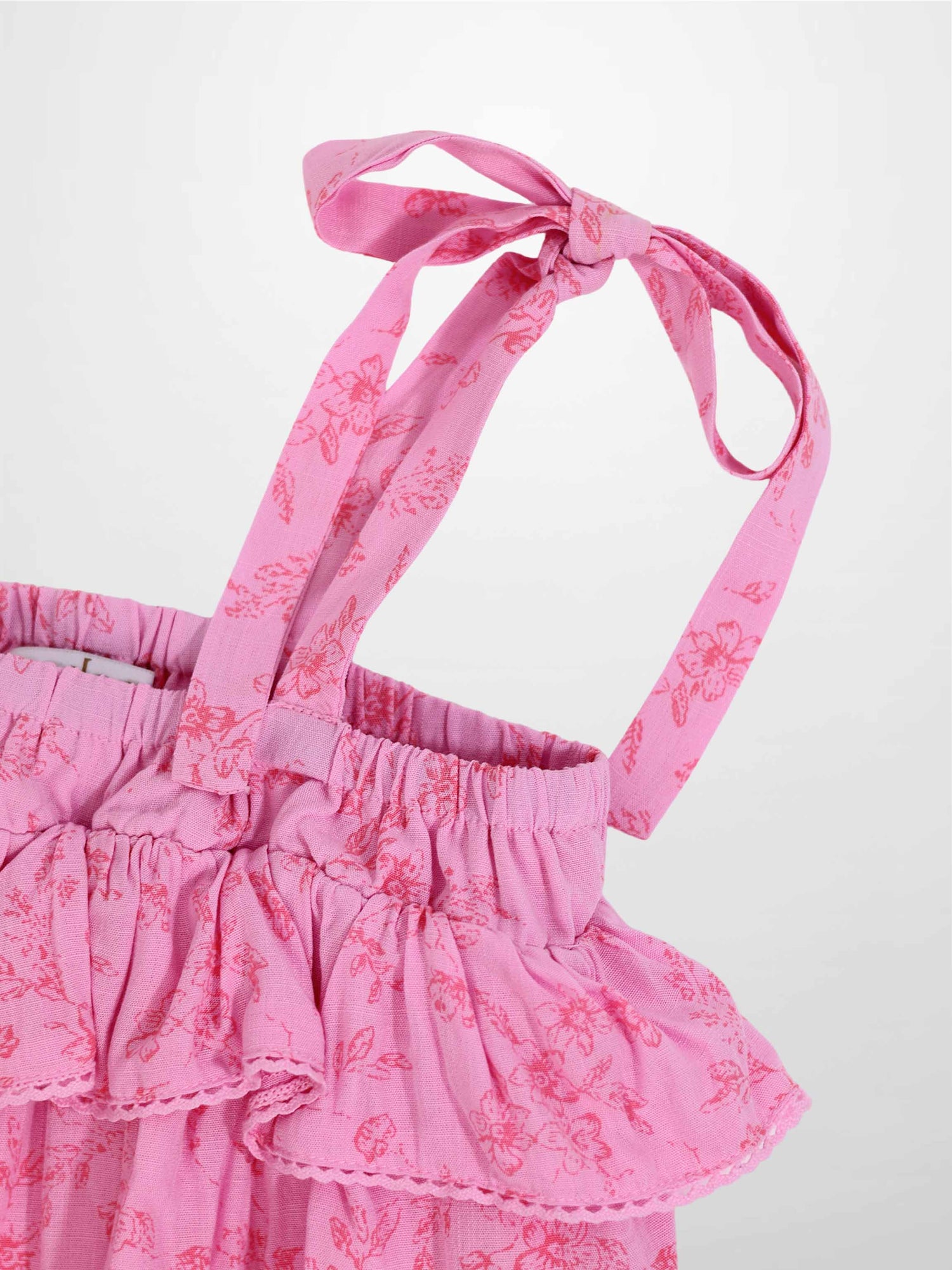 Pink flower romper for girls by Adee; dressy apparel with floral print and tied shoulder straps