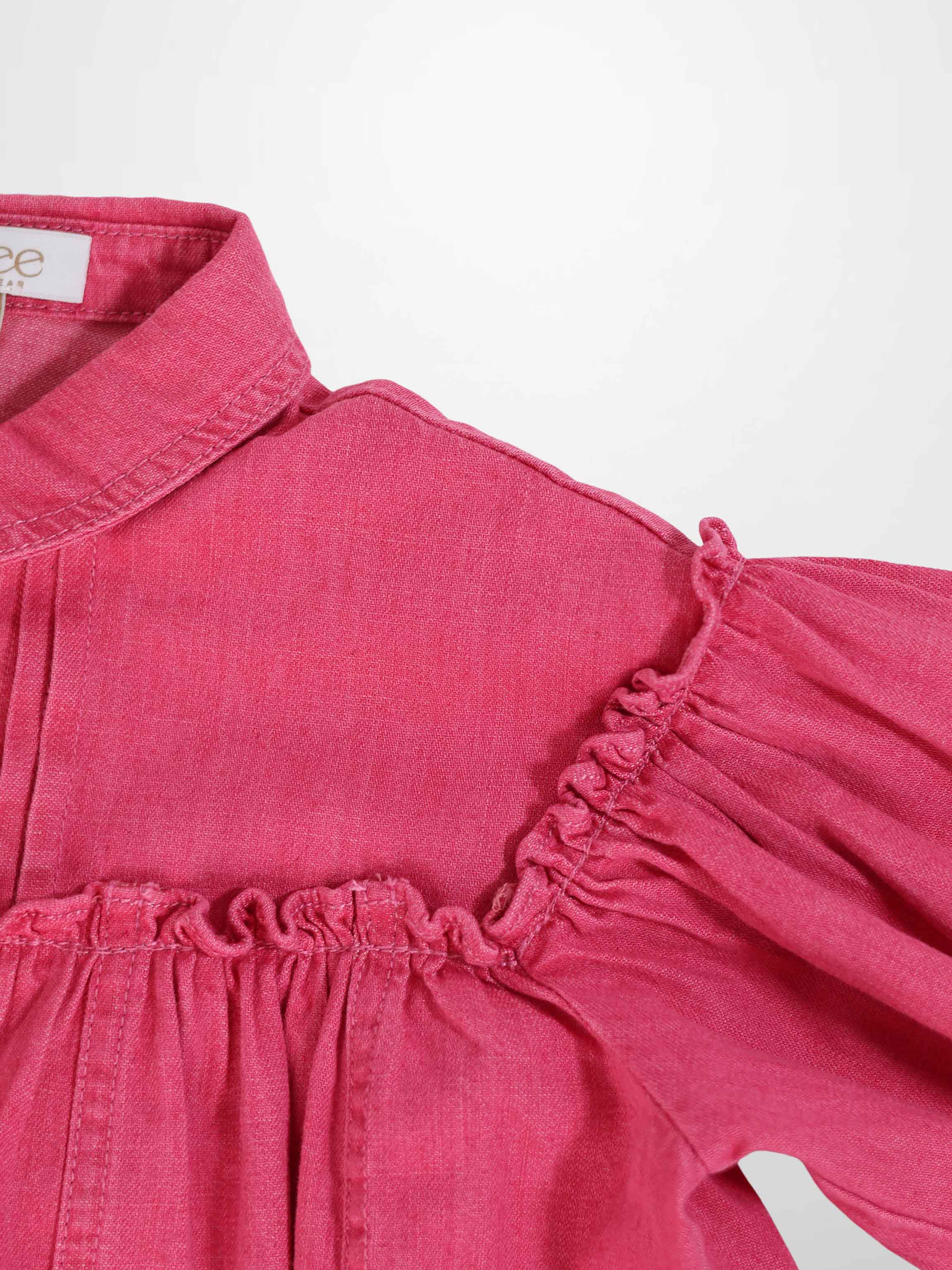 Pink denim dress with collared neckline, ruched yoke, and 3/4 sleeves.