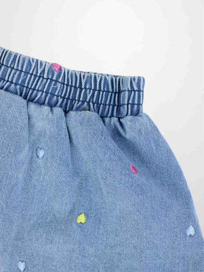 Light blue denim skirt with elastic waistband and multicolor heart embroidery