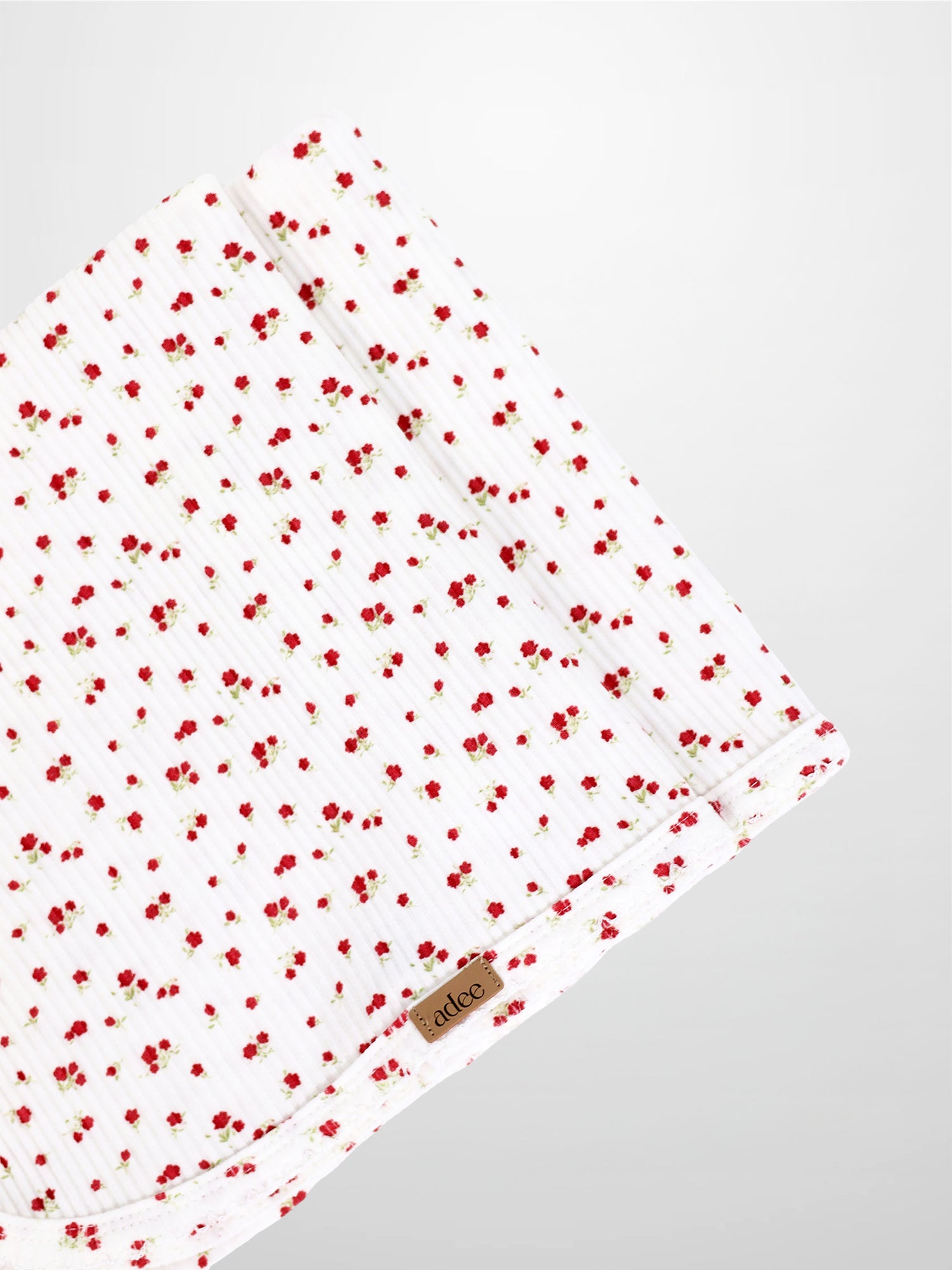 Red Flower Blanket with Lace receiving blanket by Adee; white fabric with tiny red flowers.
