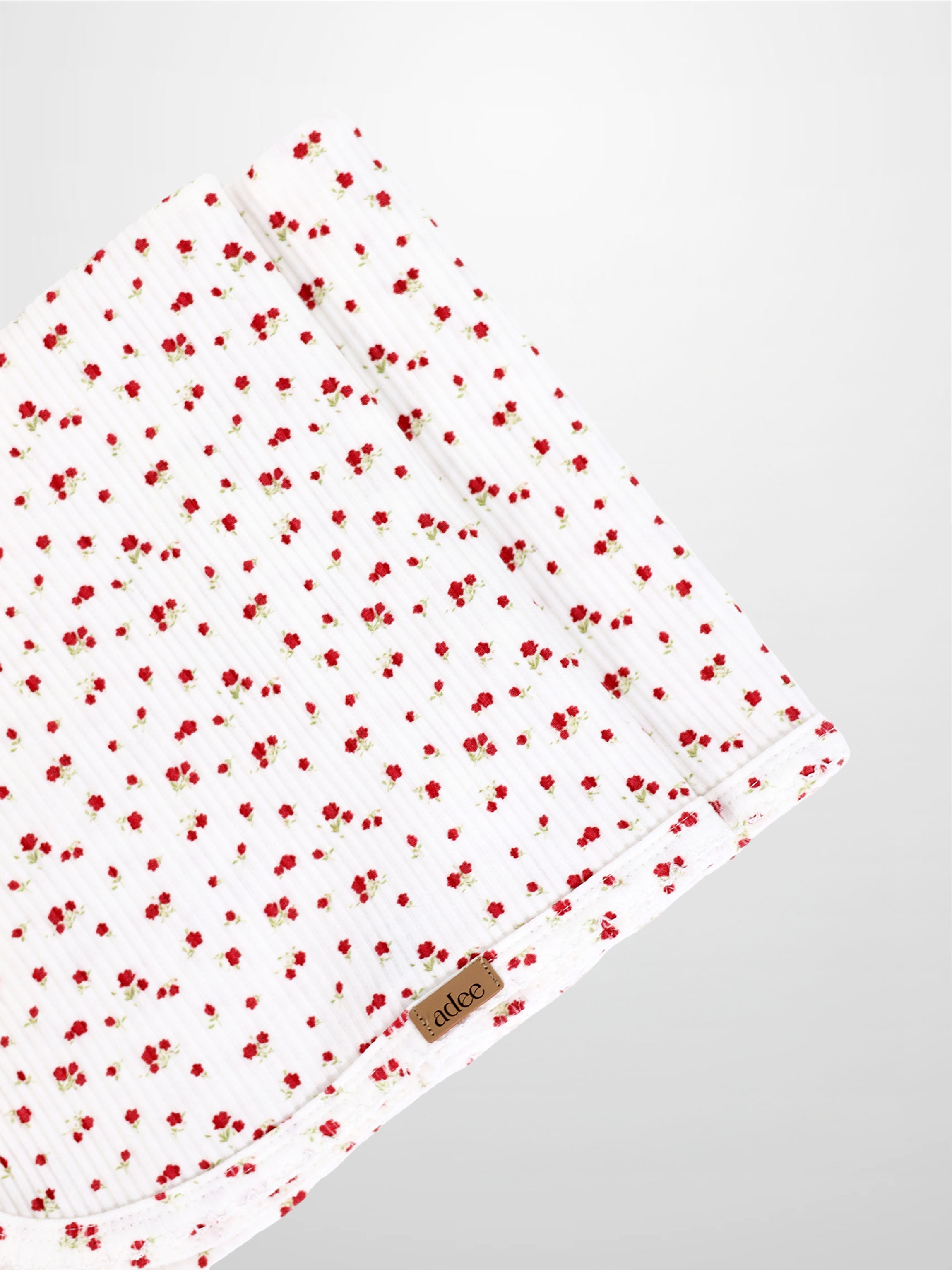 Red Flower Blanket with Lace receiving blanket by Adee; white fabric with tiny red flowers.