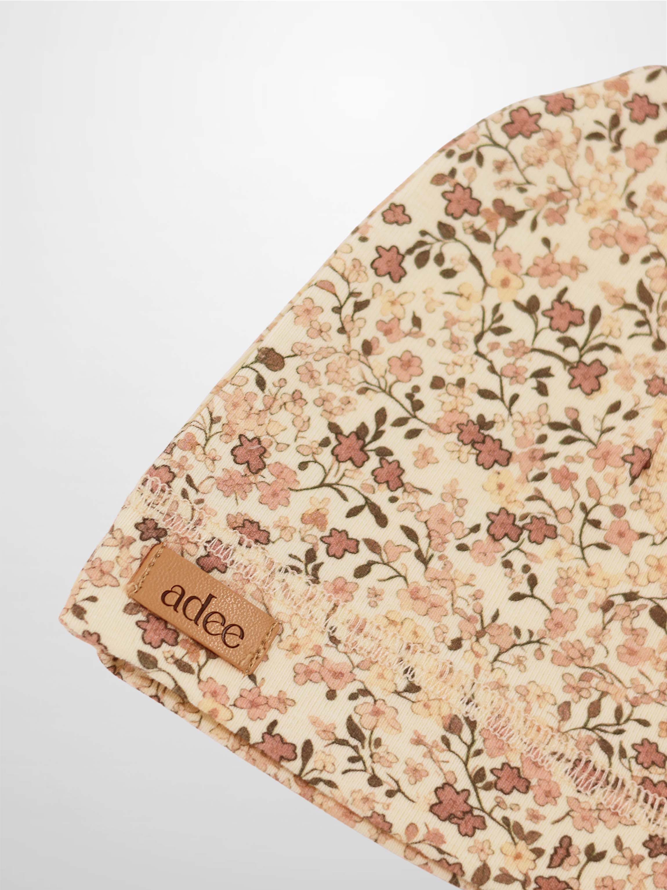 Purple Flower Hat for girls by Adee; beige fabric with all-over purple floral print.