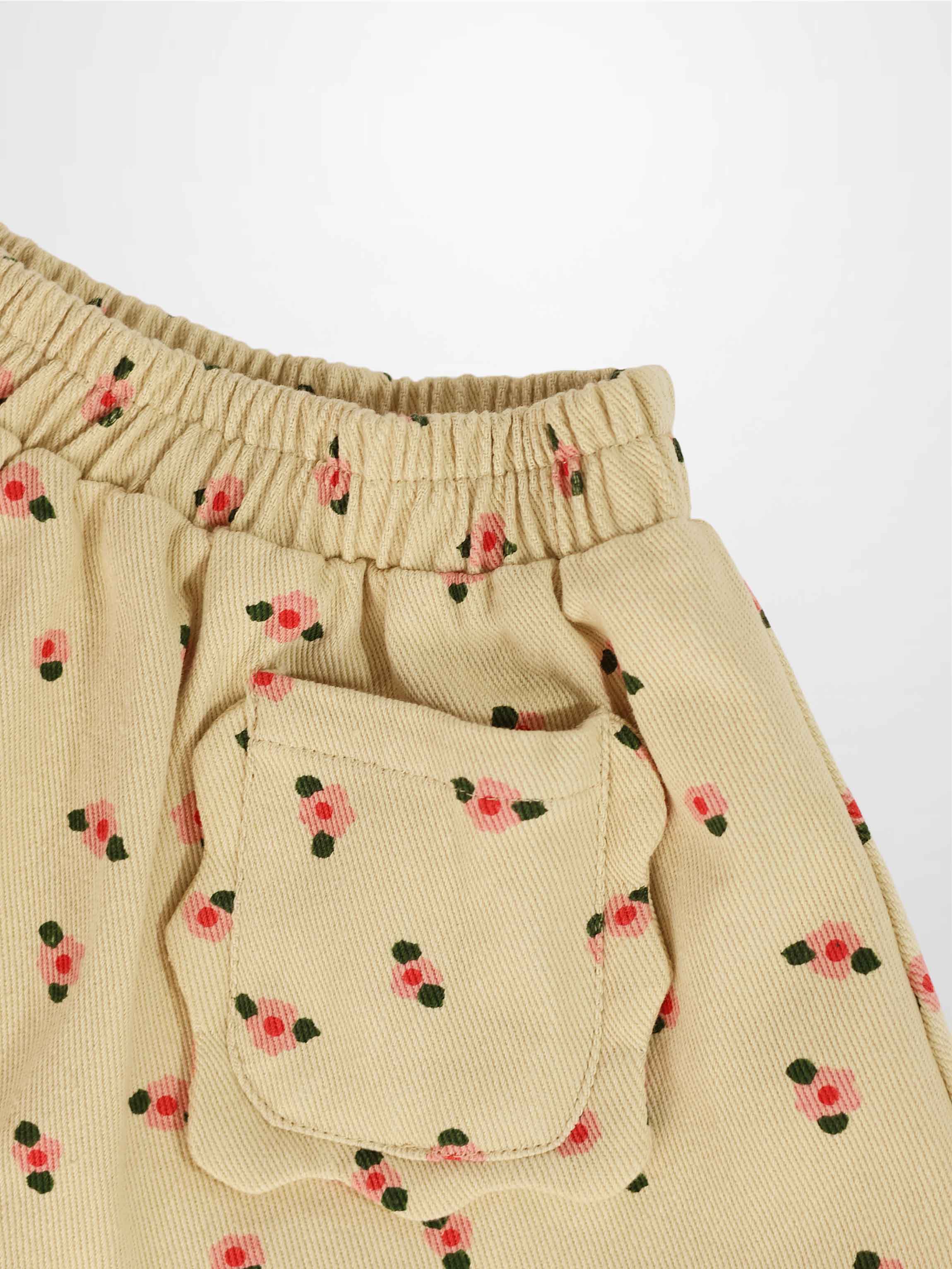 Tan Floral Skirt for girls with elastic waistband and front pocket with flap in beige corduroy with pink flowers.