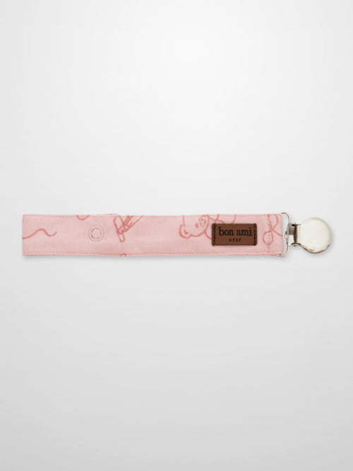 Storybook Pacifier Clip Pink fabric strap with Bon Ami label and metal clip