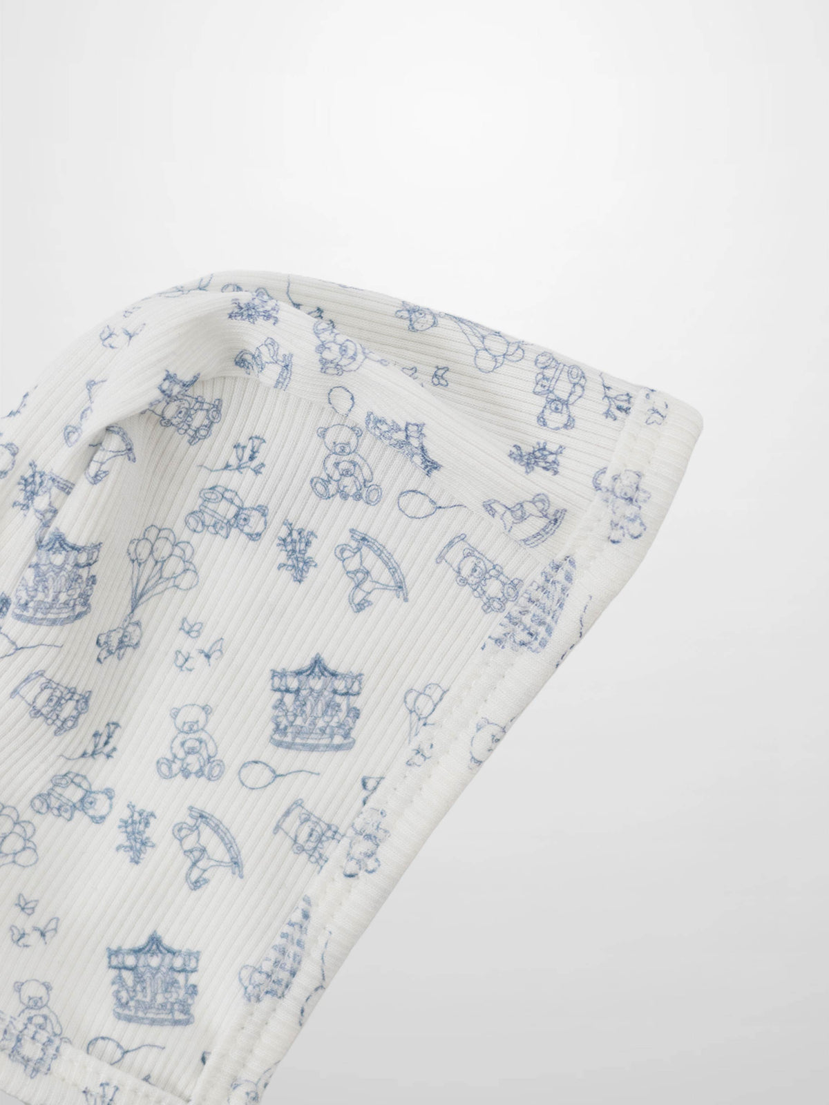 Little Storybook Bonnet - Blue by Adee; boys bonnet in white knit with a playful blue pattern.