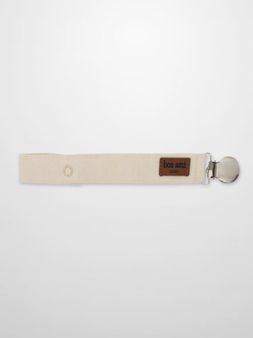 Pacifier clip beige fabric strap with metal clip and Bon Ami patch.